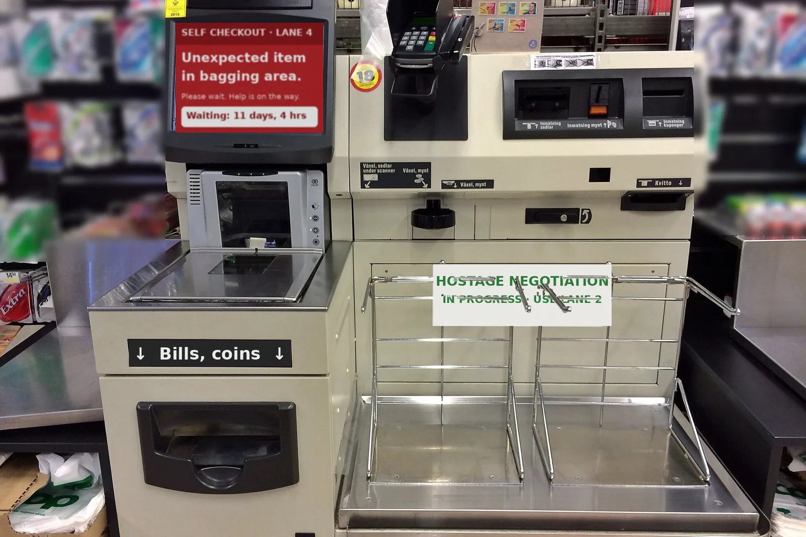 A grocery self-checkout with a red screen reading Unexpected item in bagging area, Please wait, Help is on the way, Waiting 11 days, 4 hrs, and a sign over the bagging area reading Hostage Negotiation