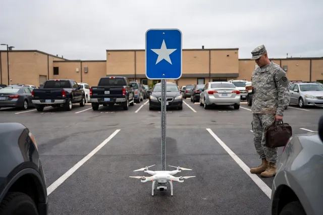 A small drone sits in a reserved general’s parking space while an Army officer with coffee and a briefcase looks down at it.